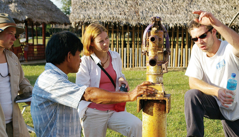 UA Engineers Without Borders demonstrate safe drinking water practices to a Peruvian villager as part of their international engaged scholarship activities.