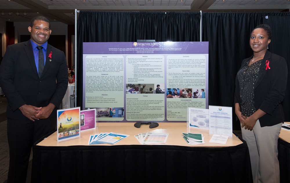 Graduate student Antonio Gardner, left, and Carol Agomo of the Office of Community Affairs were among those presenting research posters at the eighth annual CCBP Awards Luncheon. Their poster described the Saving Lives program, a faith-based wellness program.