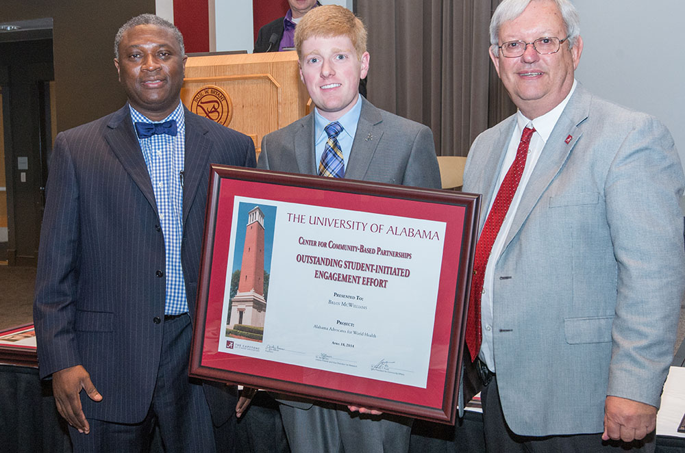 Brian McWilliams, an undergraduate in Biology, receives his Student-Initiated Engagement  award from Dr. Samory Pruitt, left, and Interim Provost Joe Benson, right.