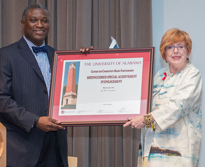 Dr. Samory Pruitt presents the Distinguished Special Achievement in Engagement award to keynote speaker Dr. Katy Campbell of the University of Alberta – Canada.