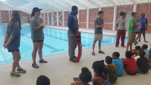 Before entering the pool for the first time participants meet instructors to discuss rules and safety precautions.