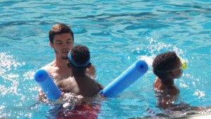 Student Stefan Casale assists with basic swim skills.