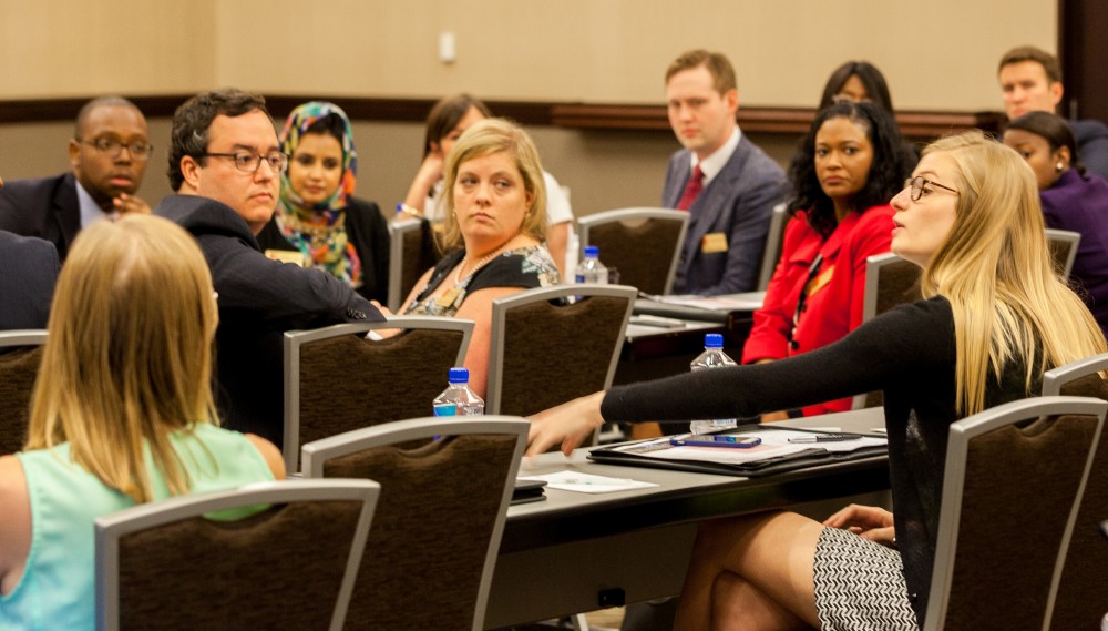 Members of the newly formed Community Affairs board of advisors listen intently to a fellow board member at the inaugural meeting of the group, held on campus in April. The group will return to campus for its next full work session in late September.