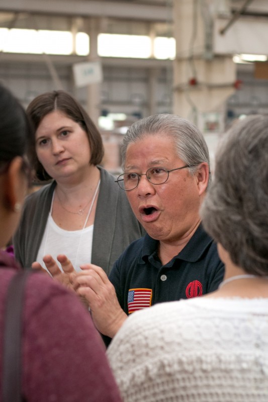 KC Pang, a former UAB professor who now serves as director of Human Resources and Corporate Affairs for GD Copper USA, Inc., speaks to tour participants inside the Golden Dragon Plant, which manufactures pipes that are used in air conditioner machinery.