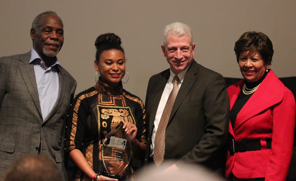 Marissa Navarro, receiving Horizon Award, accompaied by, from left, Danny Glover, Dr. Kevin Whitaker, and Dr. Cynthia Warrick.