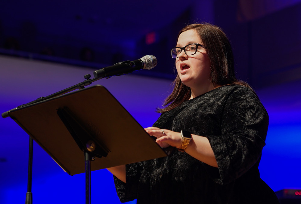 Brittney Butler, Shelton State Ambassador, speaks about the event to those gathered in the Moody Music Concert Hall for the annual Realizing the Dream Concert.