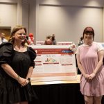Two participants with their poster presentation