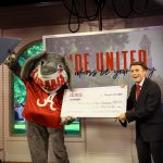 Big Al and a man holding a large check