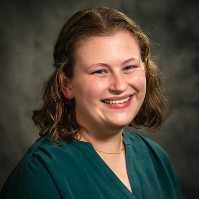 Headshot of Abigail Foes wearing a green blouse