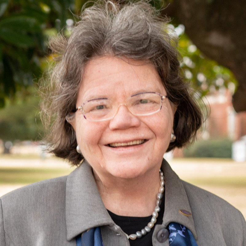 Headshot of Beverly Hawk wearing a gray colored shirt