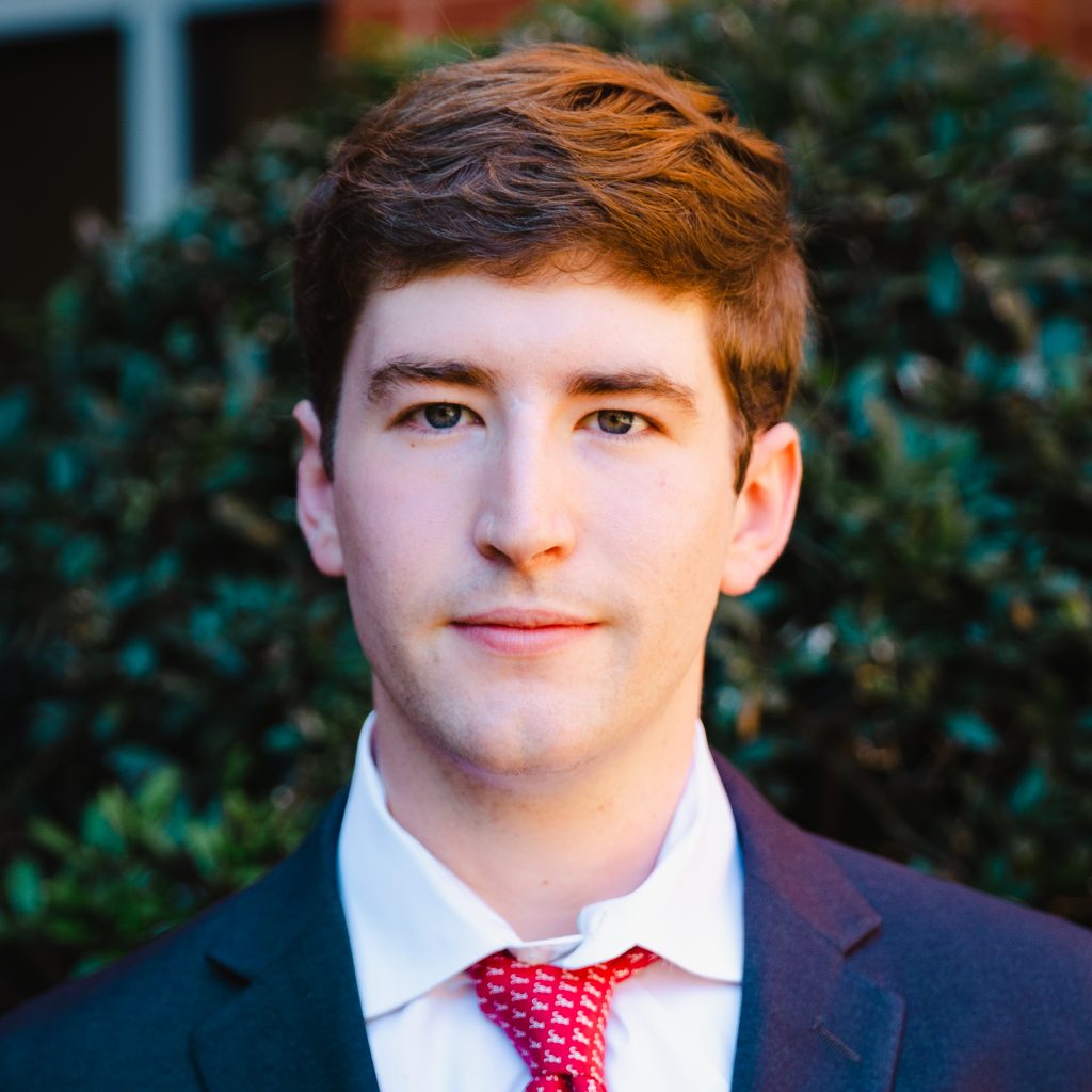 Headshot of Channler Dakota Smith wearing a blue suit and red tie