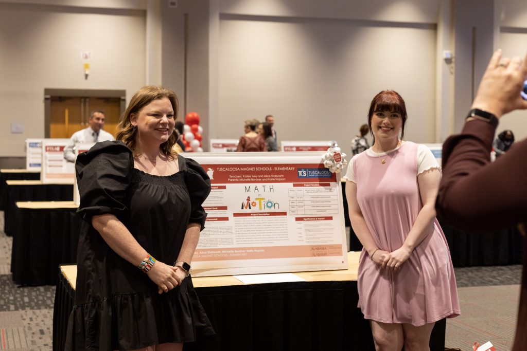 Two participants with their poster presentation