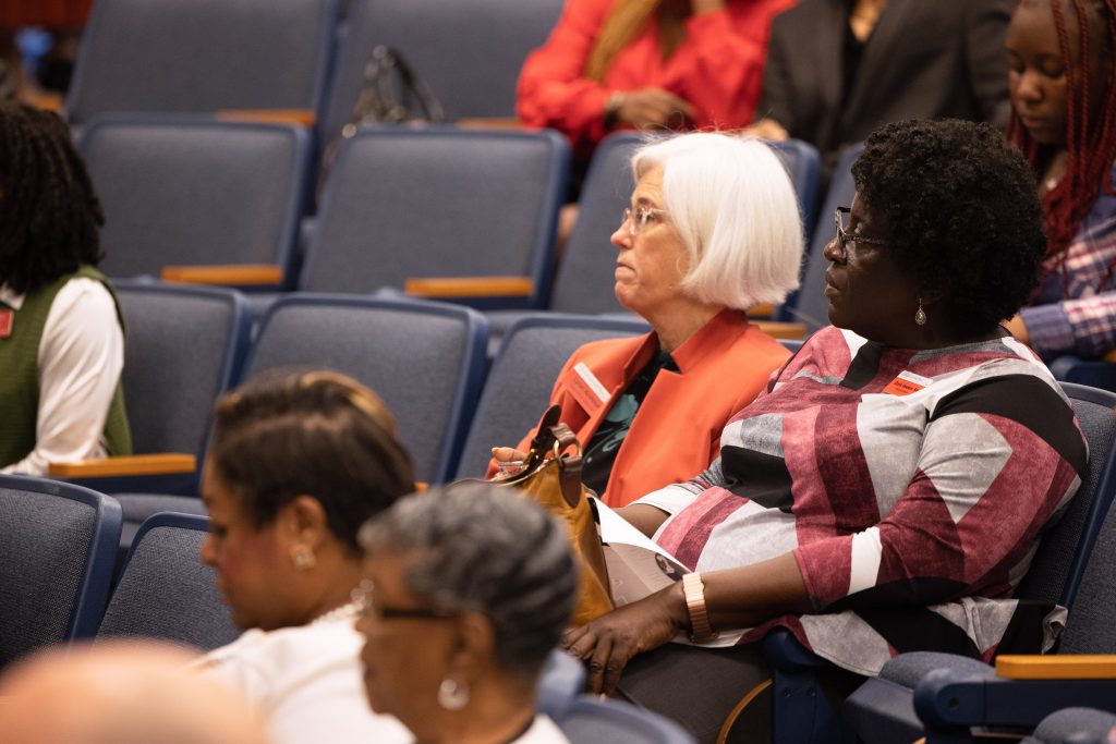 2 women listening in the stands