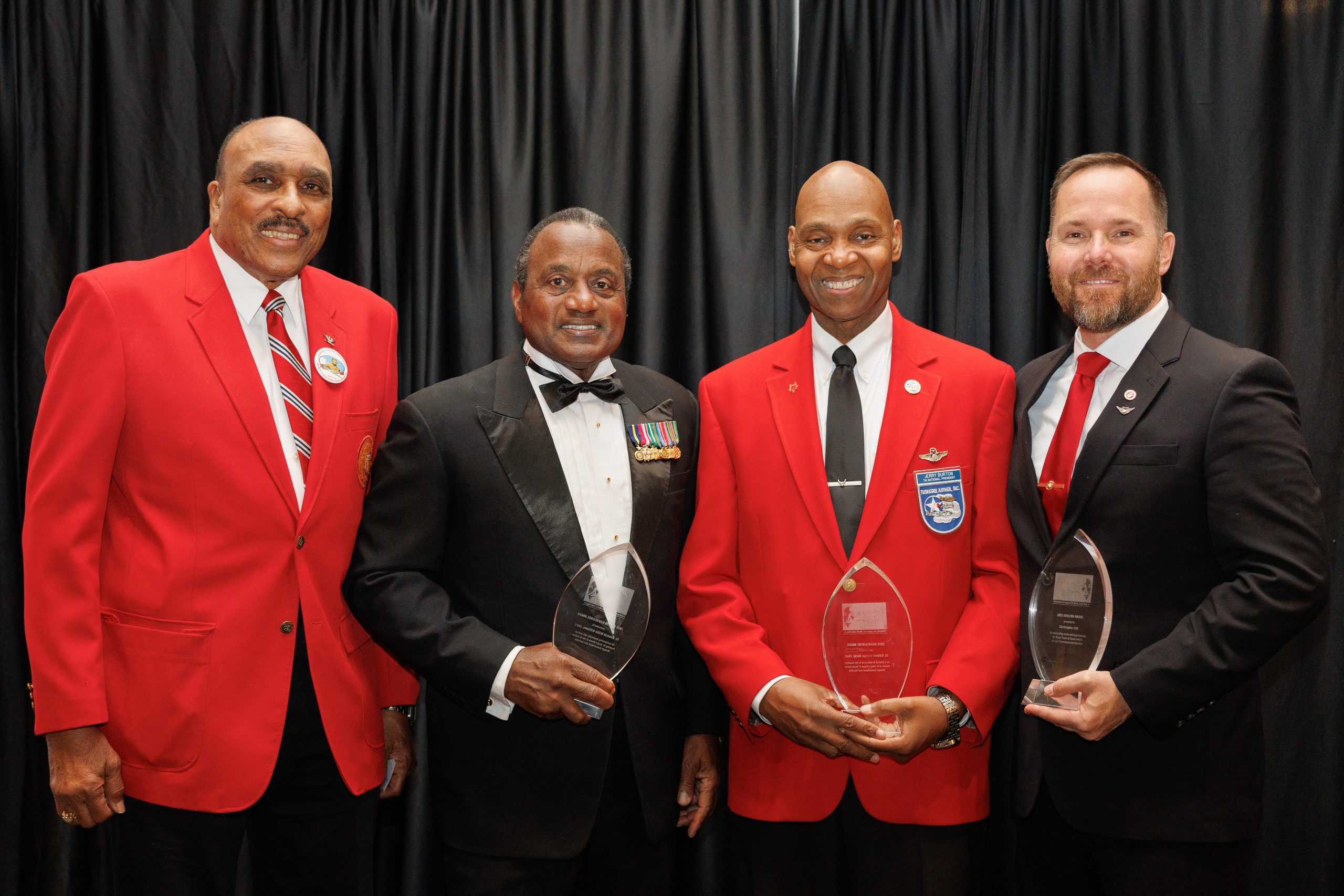 2023 Realizing the Dream Legacy Award recipients include Christopher Gill, right, recipient of the Horizon Award; Lt. General Willie J. Williams (Ret), second from left, recipient of the Call to Conscience Award; and Lt. Colonel George Hardy (Ret), not pictured, recipient of the Mountaintop Award. Accepting the award on behalf of Lt. Colonel Hardy are Palmer Sullins, left, Chairman of the Friends of Tuskegee Airmen National Historic Site, Inc., and Jerry "Hawk" Burton, second from right, national president of Tuskegee Airmen Incorporated.