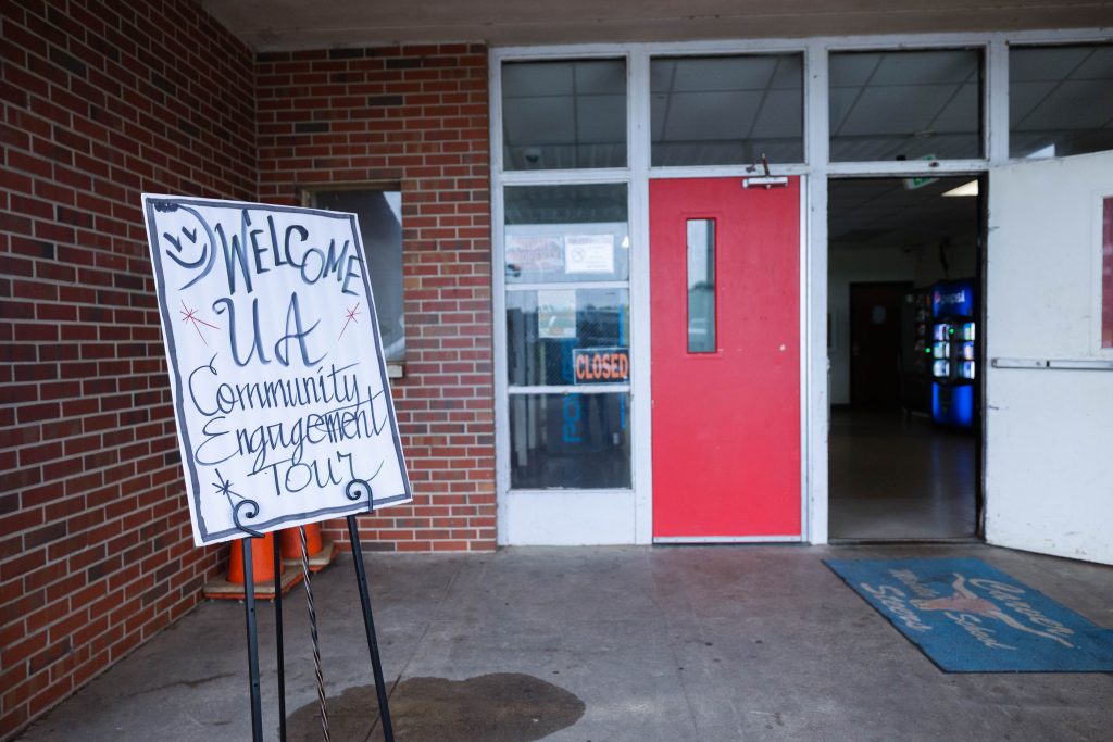 Welcome to UA sign near a red door