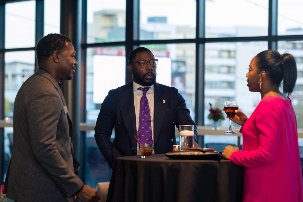 2 Men and a woman talking around a table