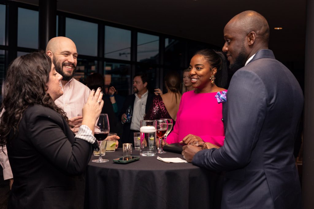 2 men and 2 women talking around a table