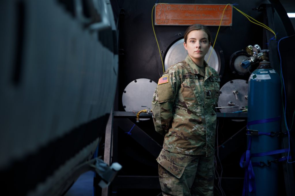 Megan Anderson standing in military fatigues