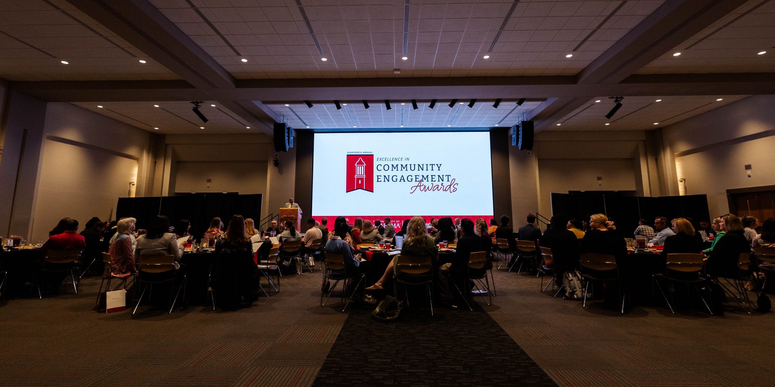 A large banquet hall room full of people attending an awards show