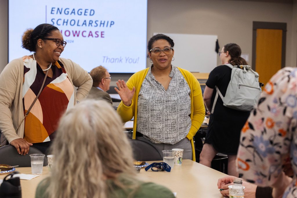 Two women talking at the Engaged Scholarship Showcase