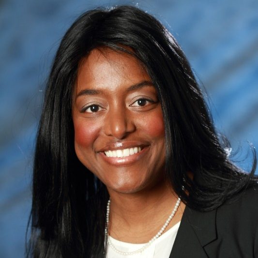 Headshot of Casey Brunson wearing a black suit jacket and white blouse