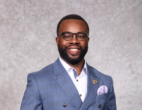 Headshot of Ibukun Afon wearing a light blue suit