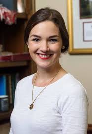 Headshot of Meg McCrummen Fowler wearing a white blouse and necklace