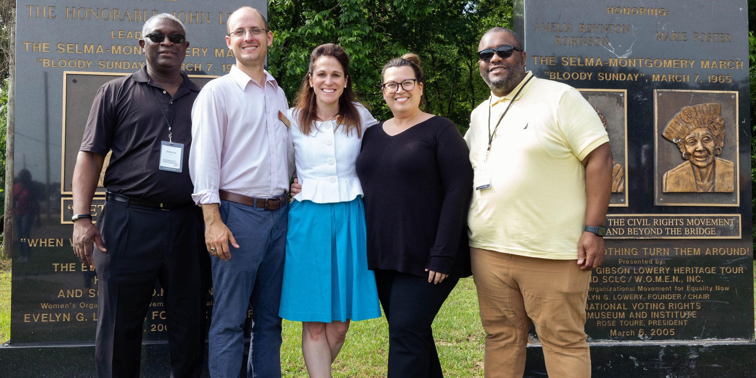 Group of people standing in front of a monument