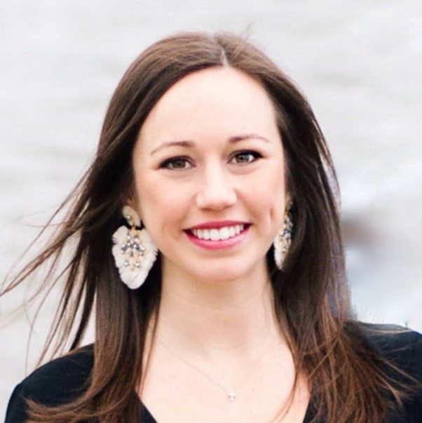 Headshot of Norma Powell wearing a black blouse and large earings