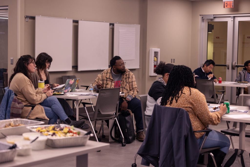 People seated at tables attending a workshop or lecture