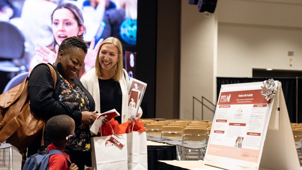 Women greeting a women with a child with PTLA gift bags