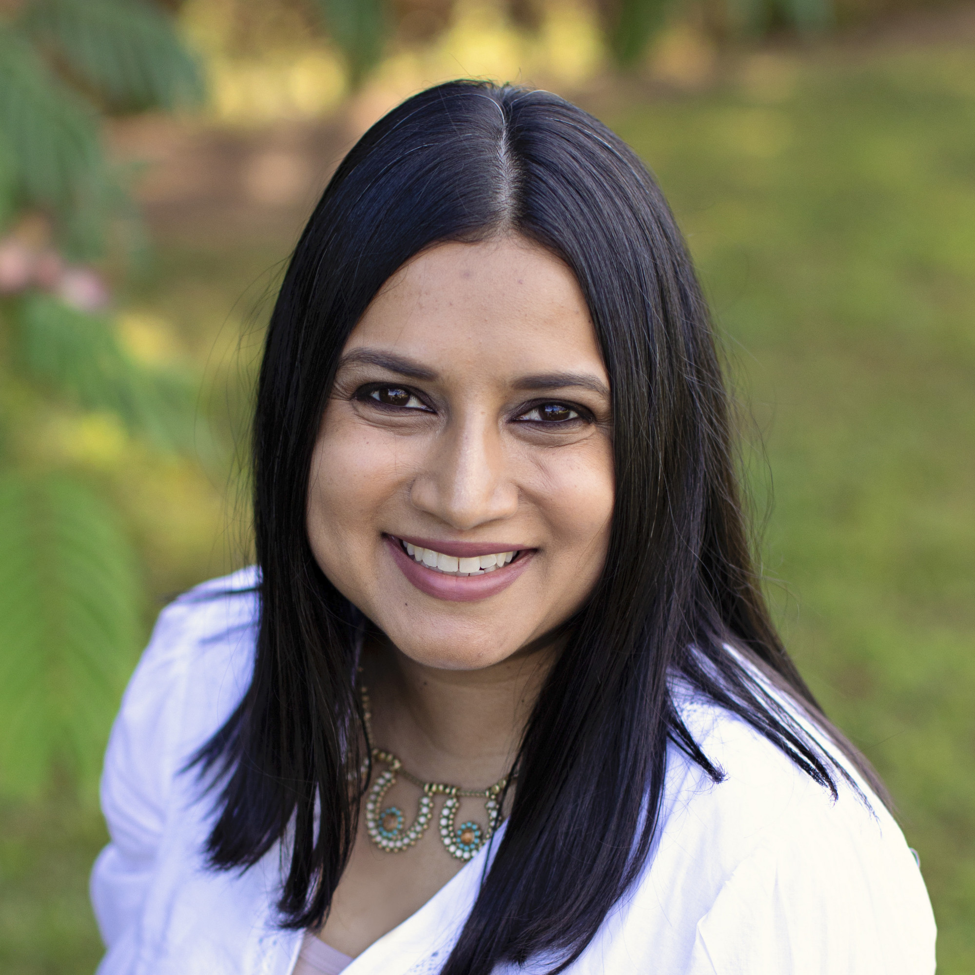 Headshot of Rashmee Sharif wearing a white blouse