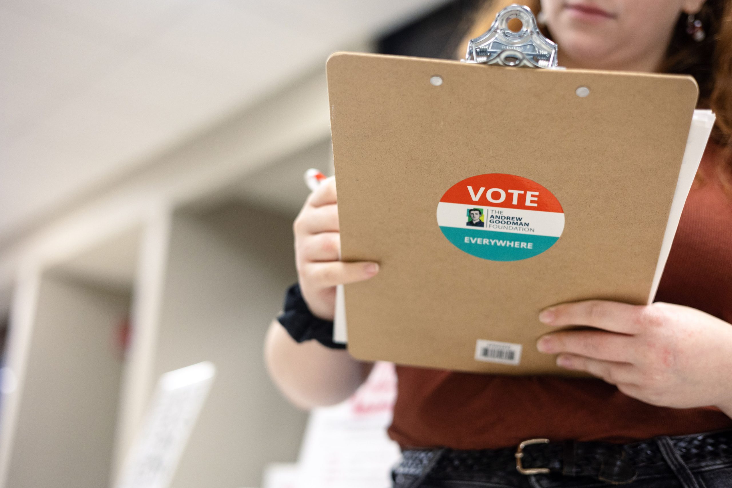 Clipboard with Register To Vote sticker on it