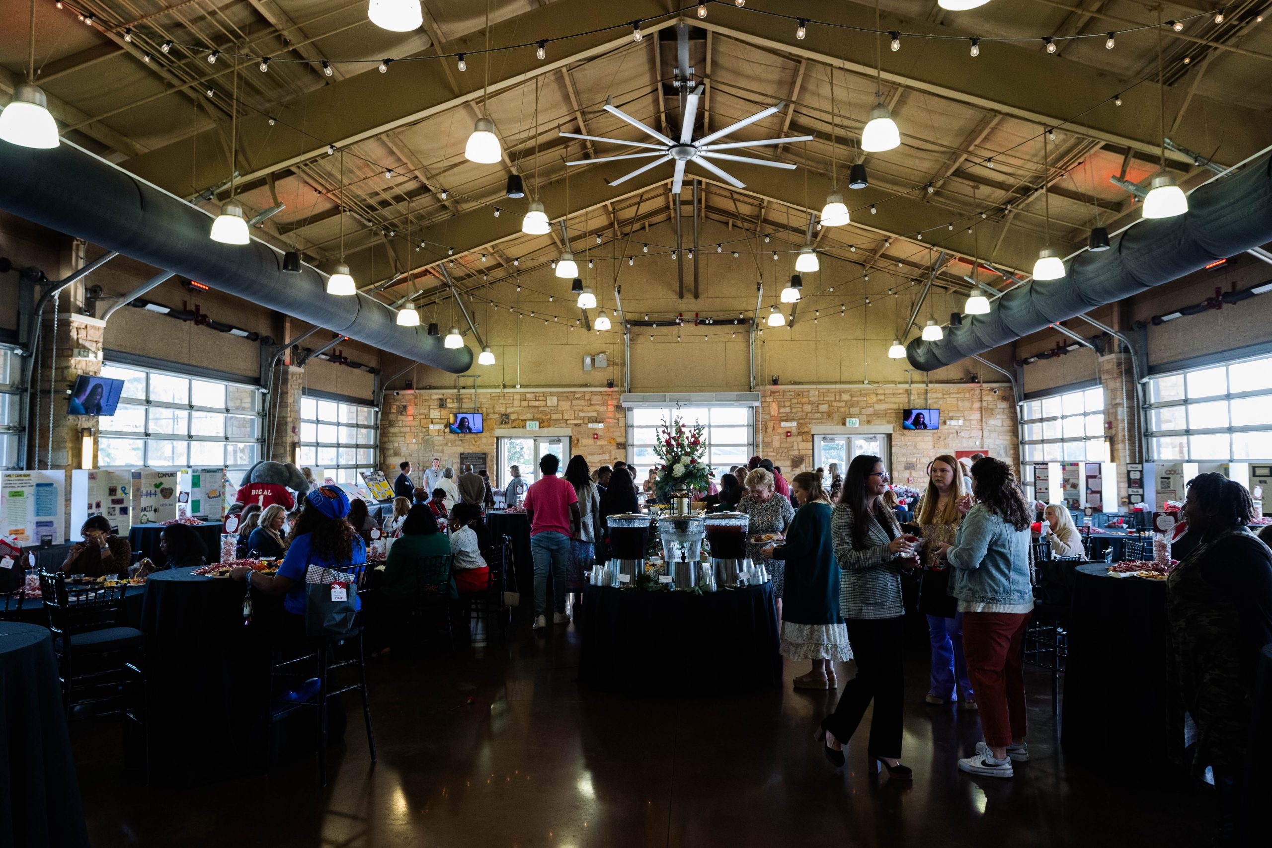 People gathered in a building with food and drinks