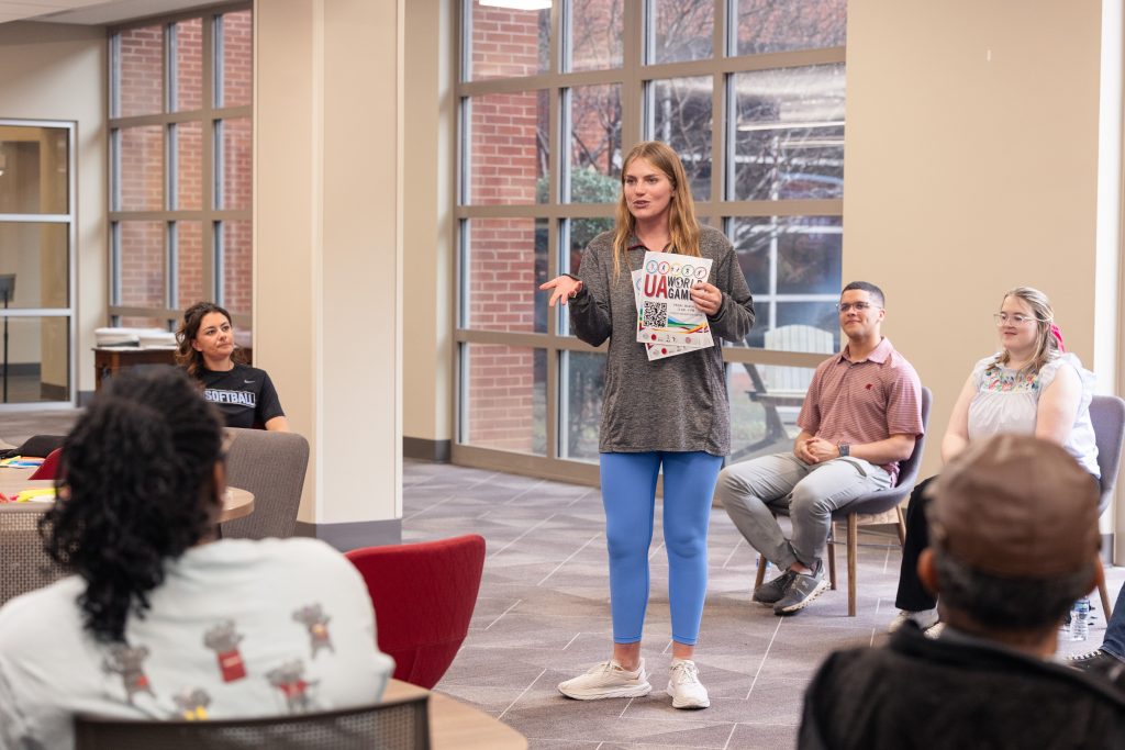 Girl presenting flyer to other students