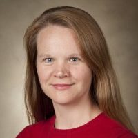 Headshot of Sarah Dunlap wearing a red shirt