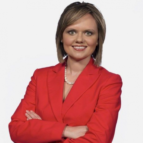 Photo of Terri Brewer wearing a red suit jacket