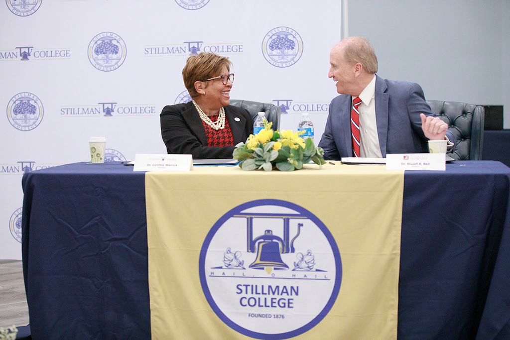 UA President Stuart R. Bell and Stillman College President Cynthia Warrick seated at a table, smiling