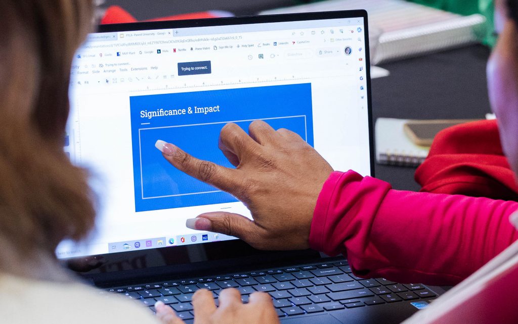 People working on presentation on a computer